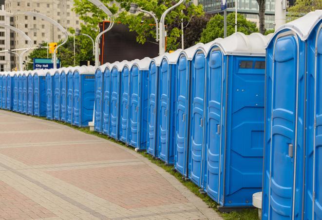 a row of portable restrooms at an outdoor special event, ready for use in Kannapolis